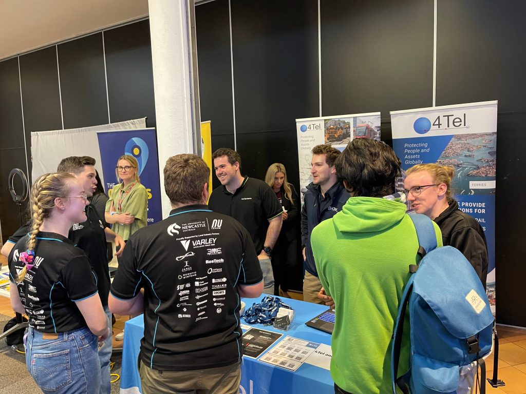4Tel staff connecting with students and graduates at the 4Tel stall during Newcastle Tech Futures Day 2023.