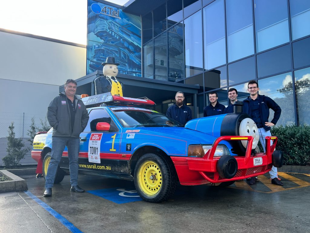 Driver Mick Freund and some of the 4Tel team next to bash car TOM1.