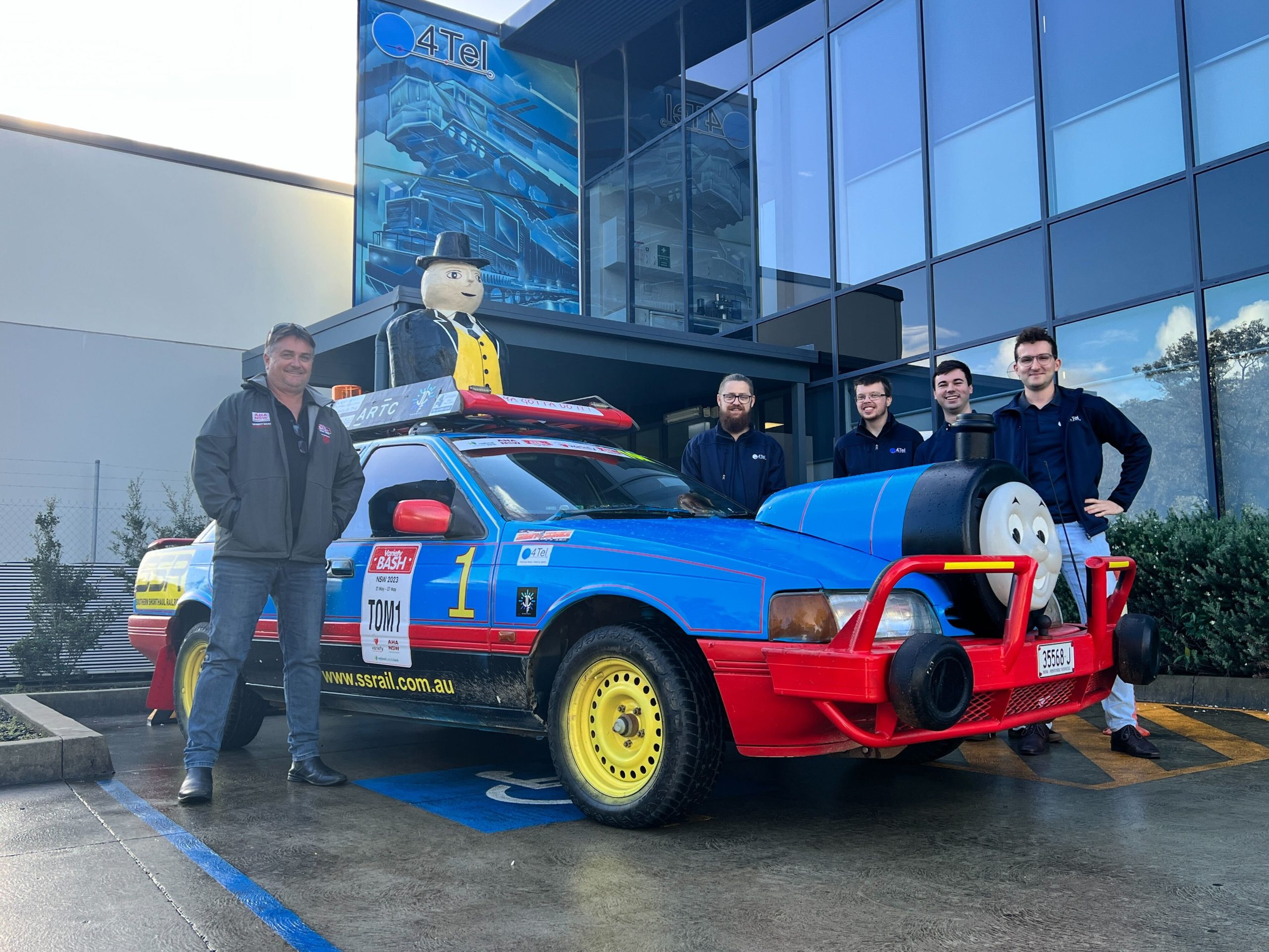 Driver Mick Freund and some of the 4Tel team next to bash car TOM1.
